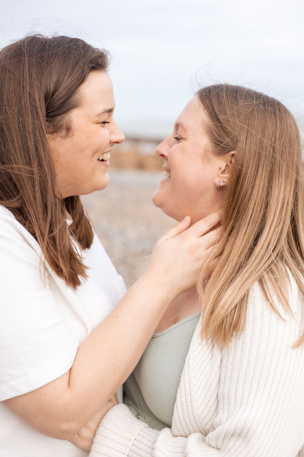 two women embracing on eastbourne beach
