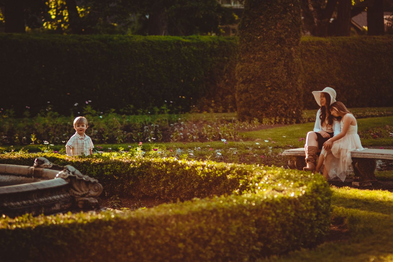 People enjoying a golden sunset in a peaceful garden setting. Family Photography