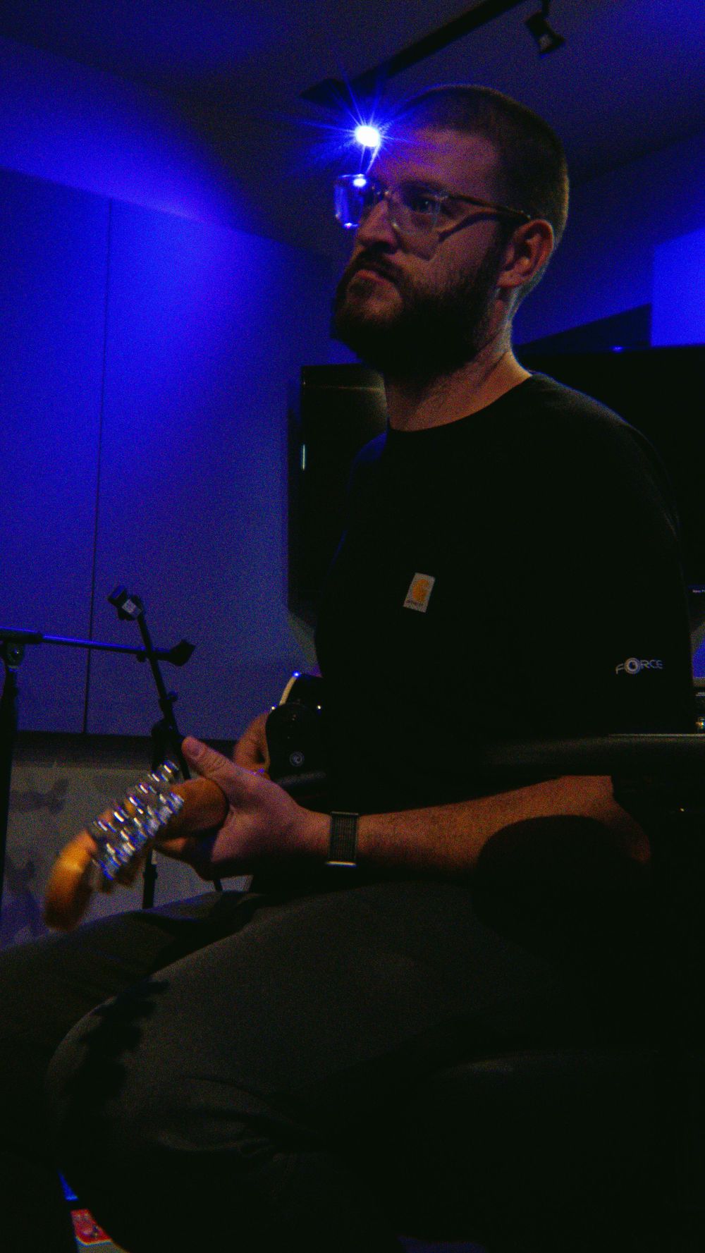 A man holding a guitar and talking