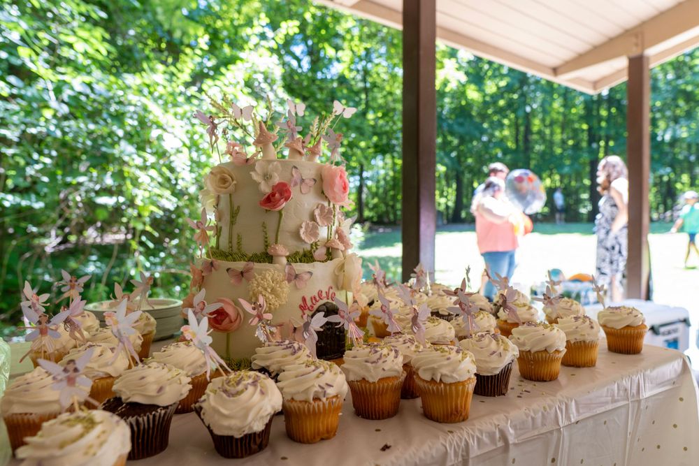An array of cupcakes and cake on a table