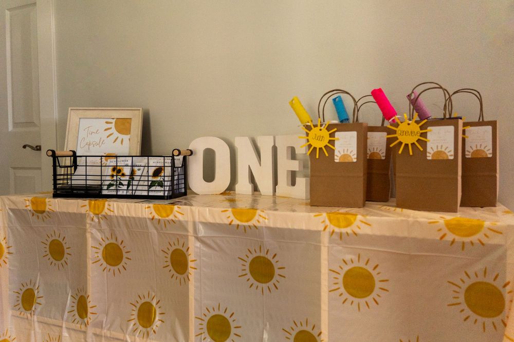 A first birthday set up with gift bags