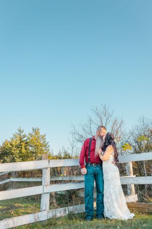 Bride and Groom kiss in front of field. Milwaukee Wisconsin Weddiing Photography