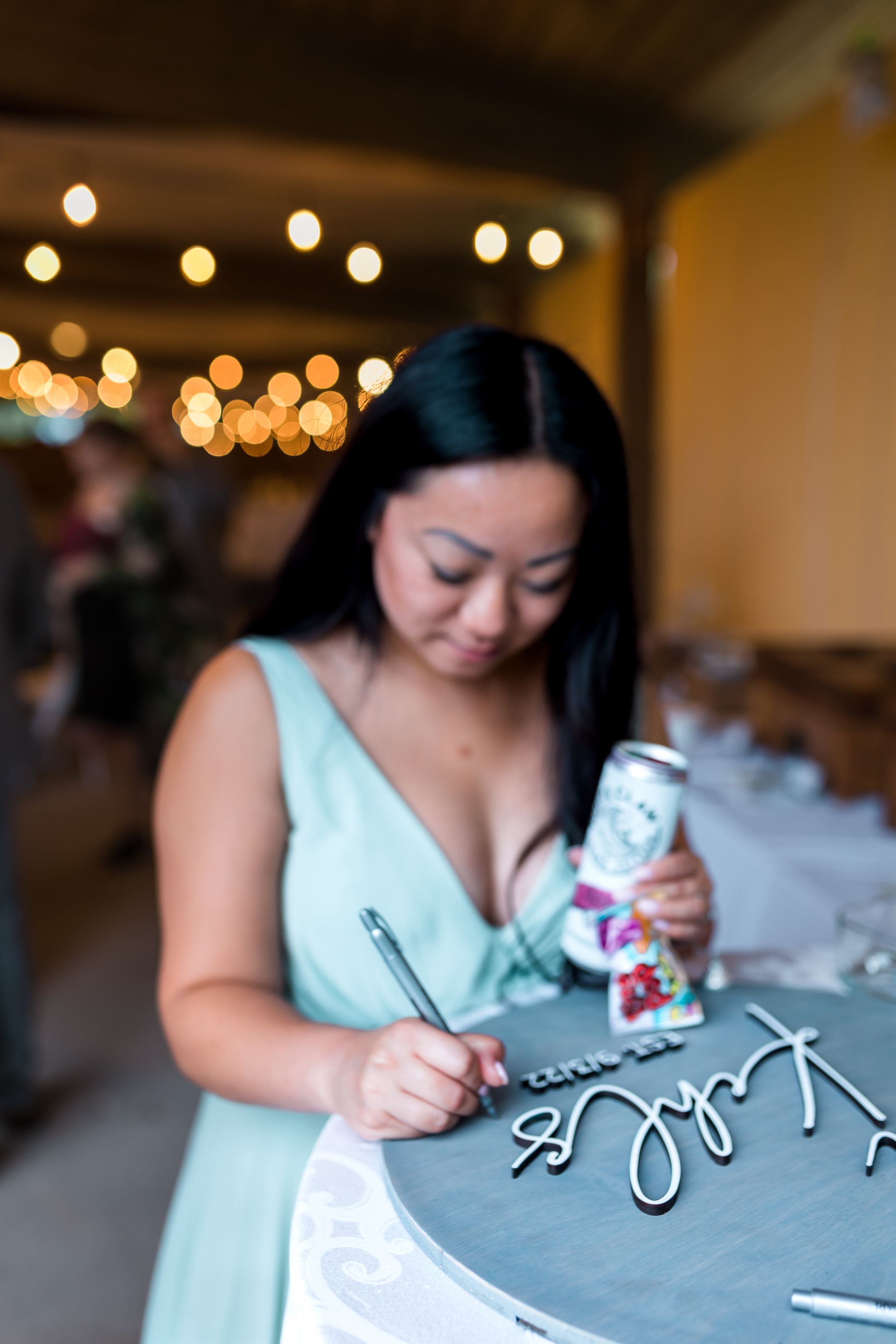 bridesmaid signs a newly wed's keepsake at wedding in lake genava milwaukee wisconsin