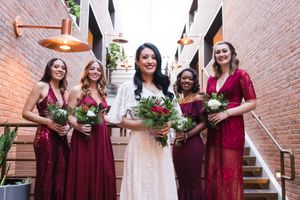 Bride and bridesmaids in Christmas wedding posed and facing camera