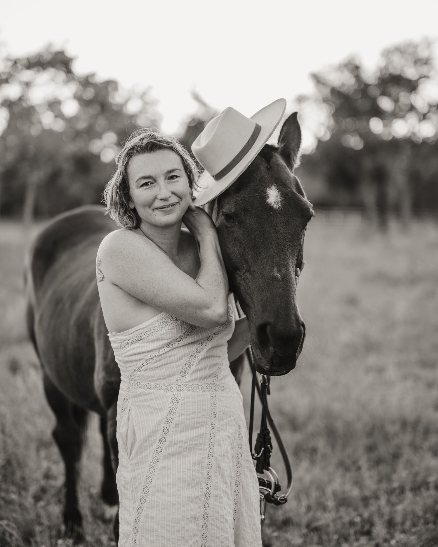 Black and white portraits showing affectionate interactions between a person and their horse in a field.