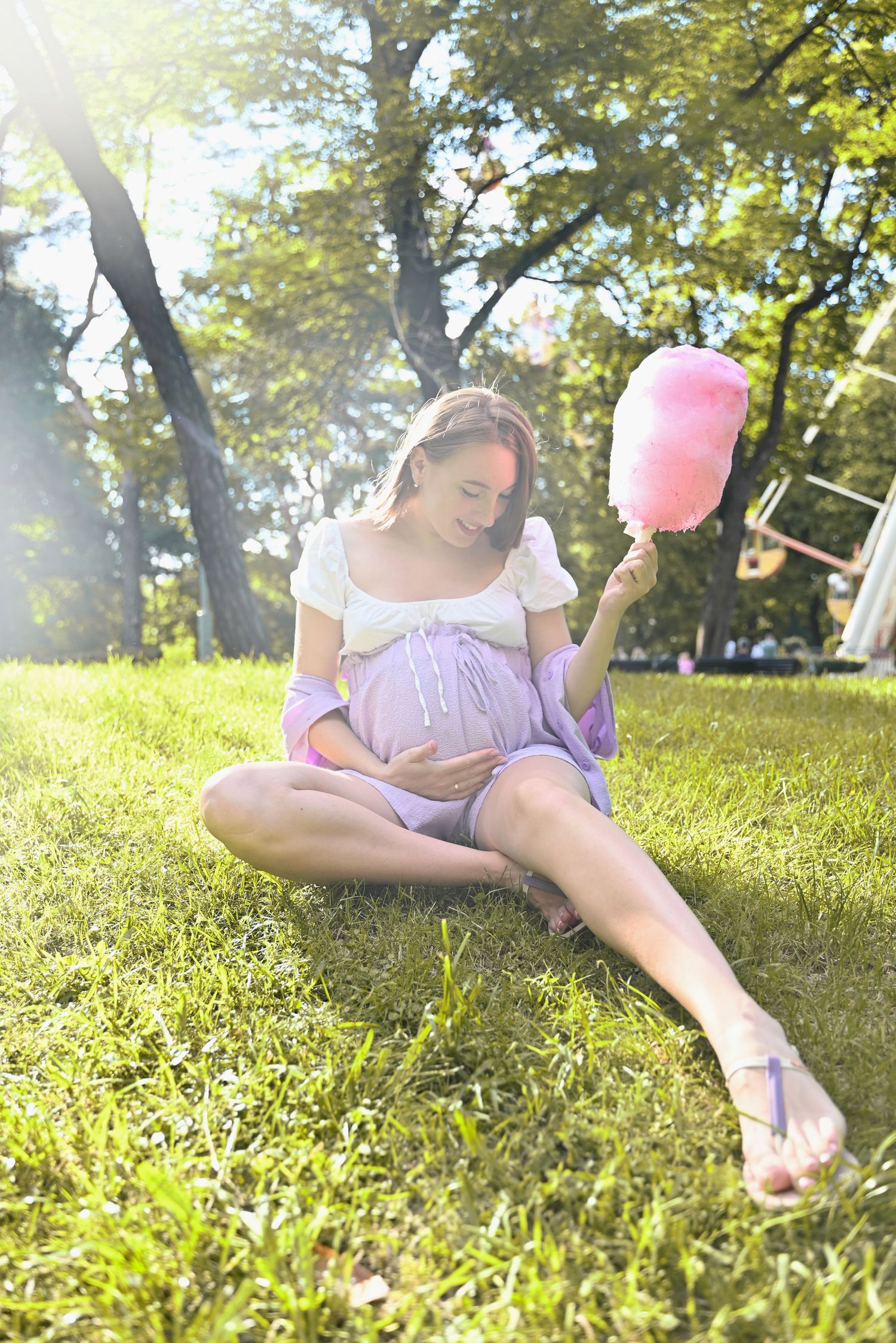 A pregnant woman sitting in a park