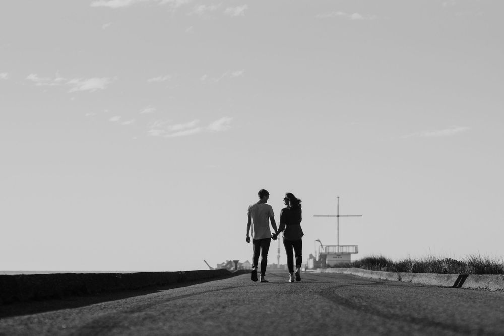 couple walking down the road at Blaketown breakwater in Greymouth