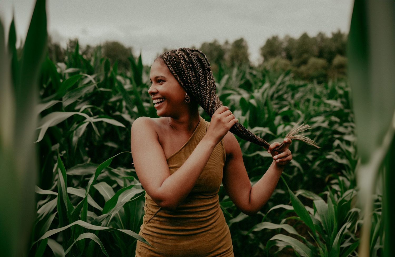 Candid moment of joy captured in a lush green cornfield during summer.