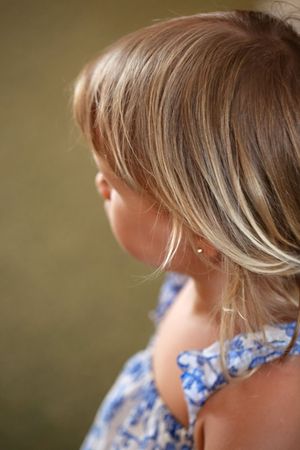 Close up side profile of blonde hair with soft natural lighting.