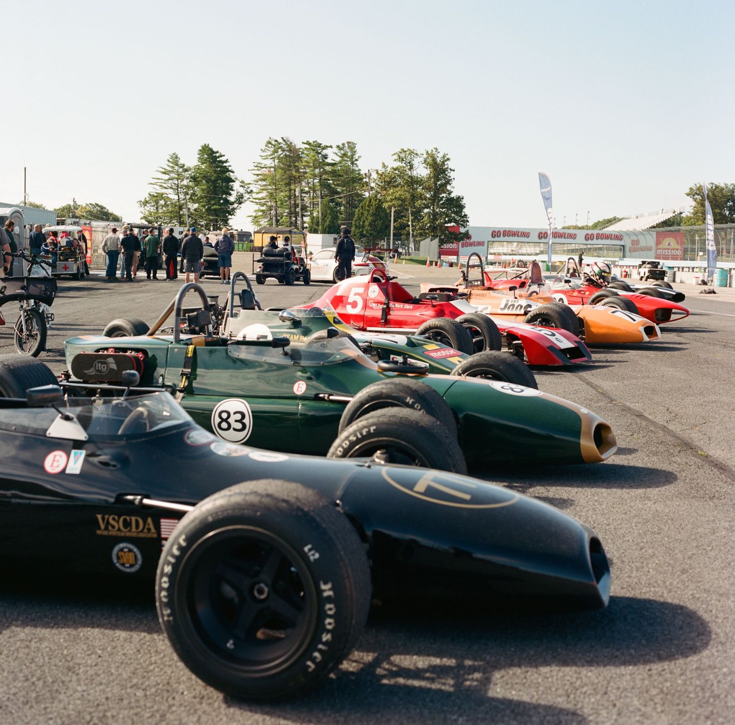 Vintage formula car trackside lineup at Watkins Glen.