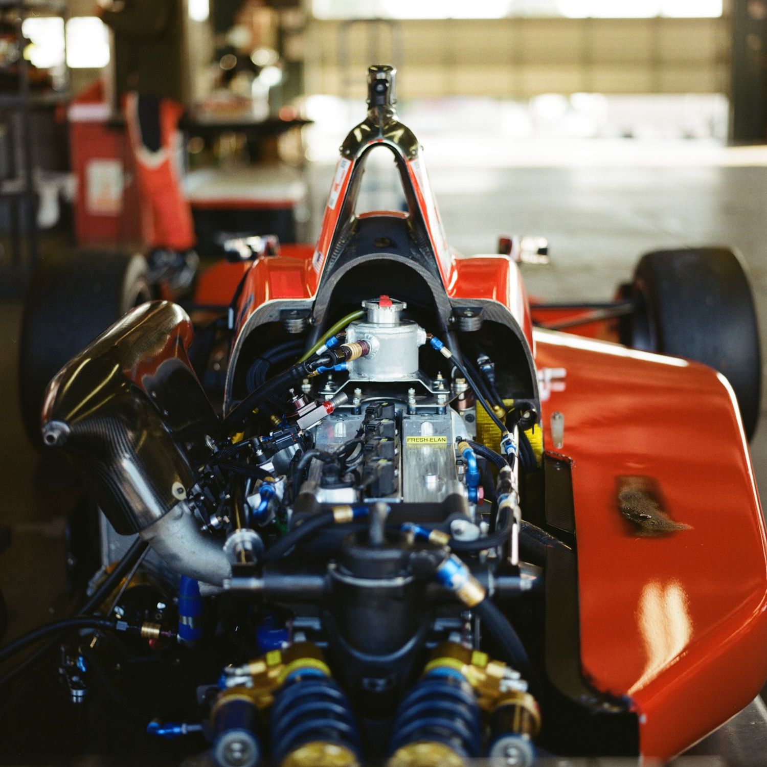Red race car as shot in Watkins Glen's Vintage Grand Prix. Taken on film with a Bronica SQ.