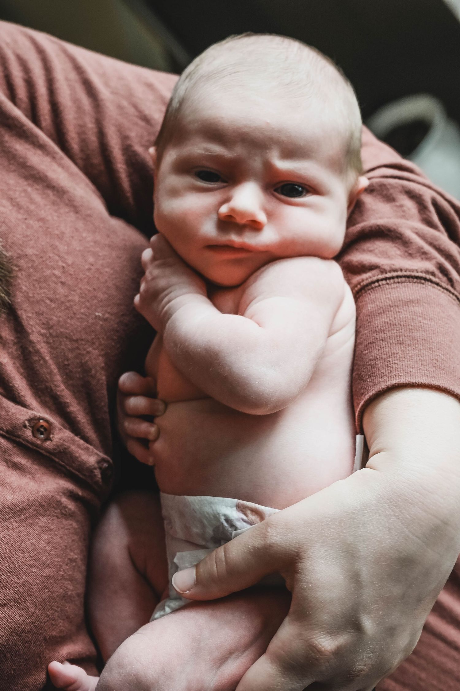 Newborn baby girl makes a scowling face during newborn session near Albany, NY