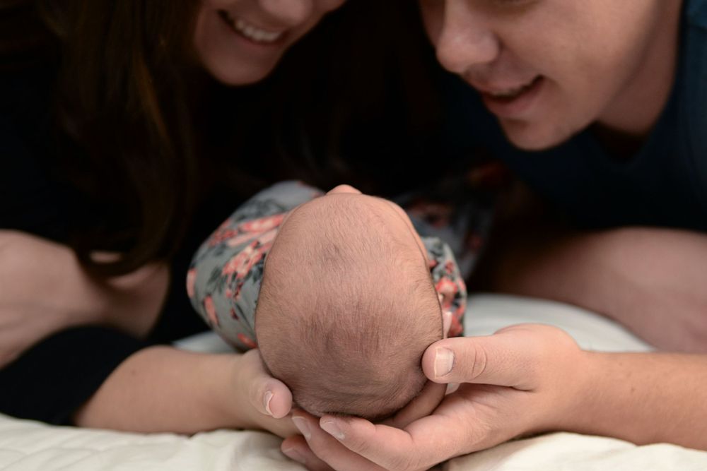 Black and white close-up portrait showing gentle interaction with baby.