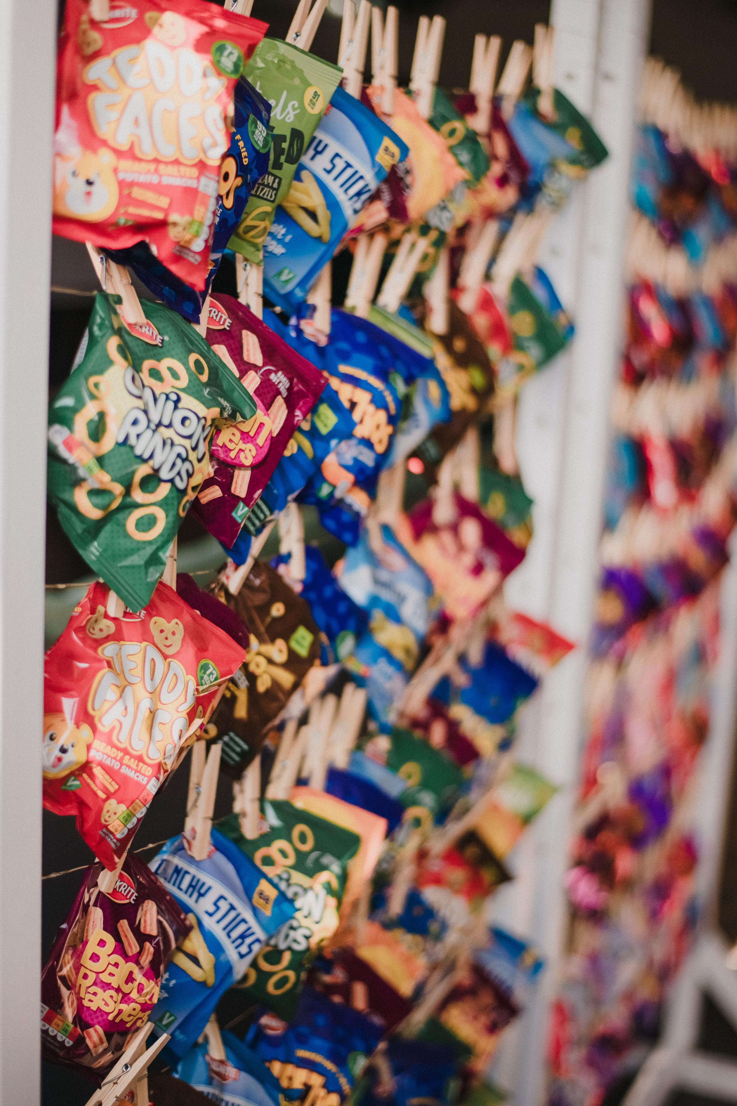 Colorful bags of snacks and treats arranged in diagonal rows on display.