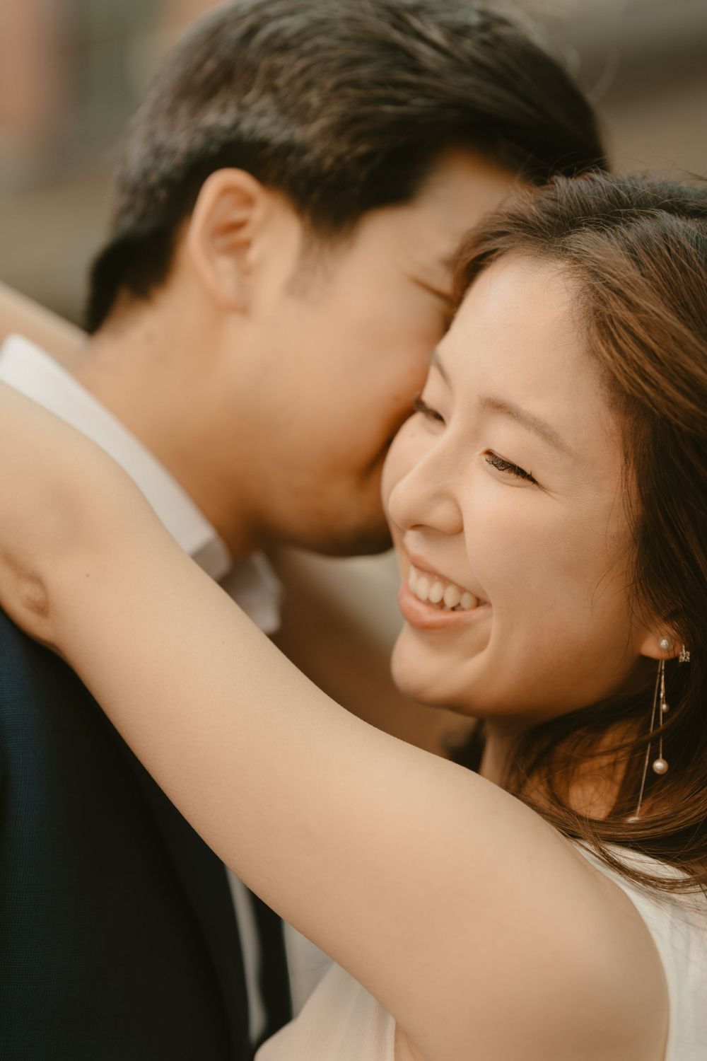 A tender intimate moment captured in warm natural lighting with soft focus.