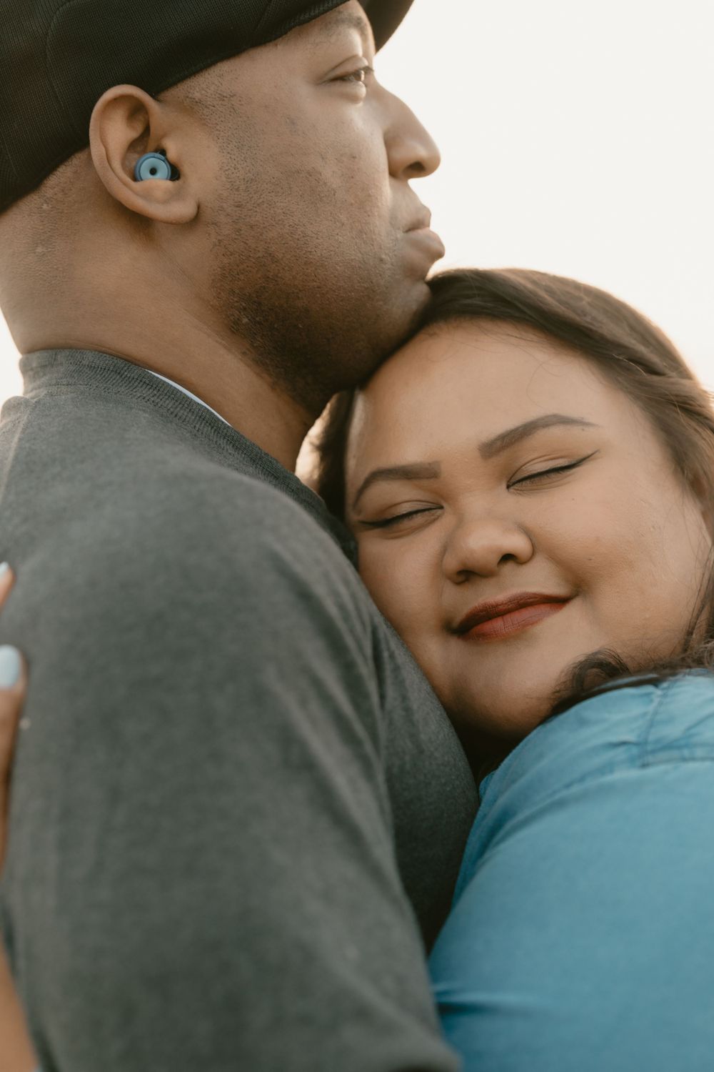 Close-up intimate portrait of couple sharing tender embrace.