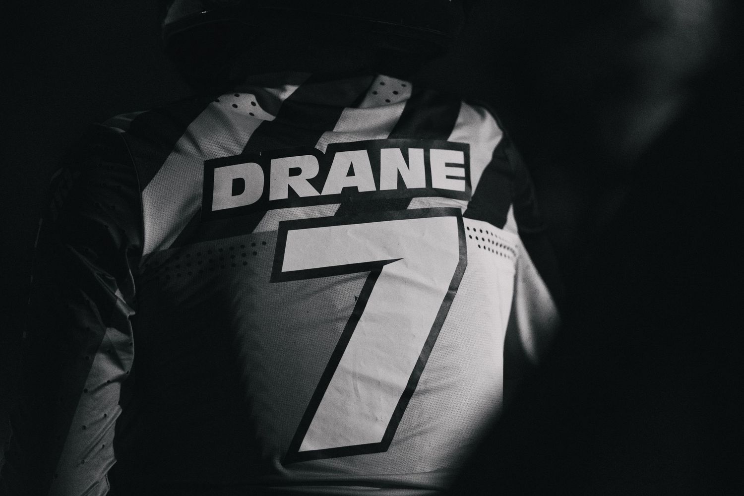 Black and white photo of athlete wearing jersey number 7 with name DRANE on the back.