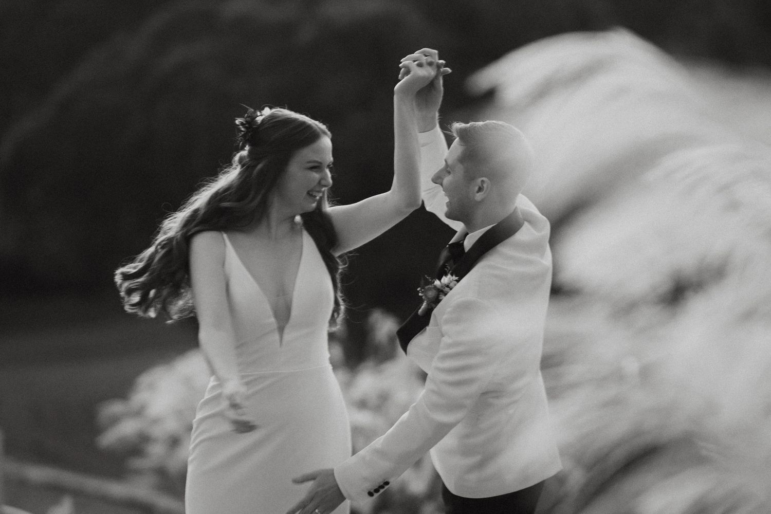 Artistic black and white motion blur photo capturing movement in an outdoor setting.