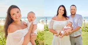 New parents posing with their baby outdoors near the beach, mother in white dress.