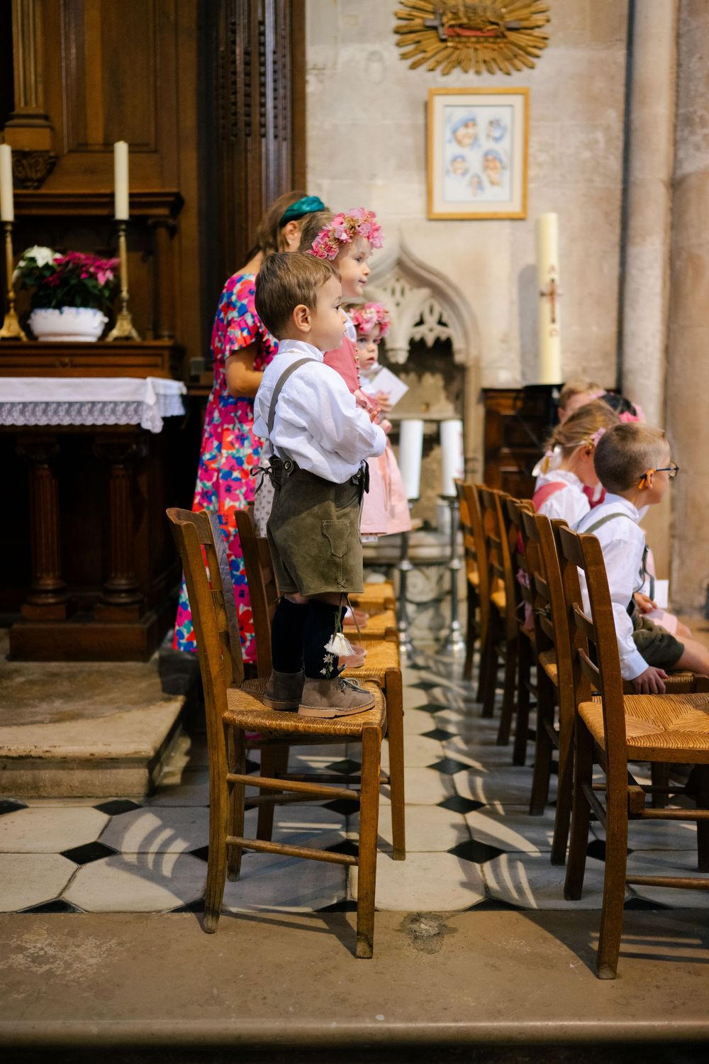 A sequence of four photos showing a couple dancing together in a church, with colorful traditional dress and movement.