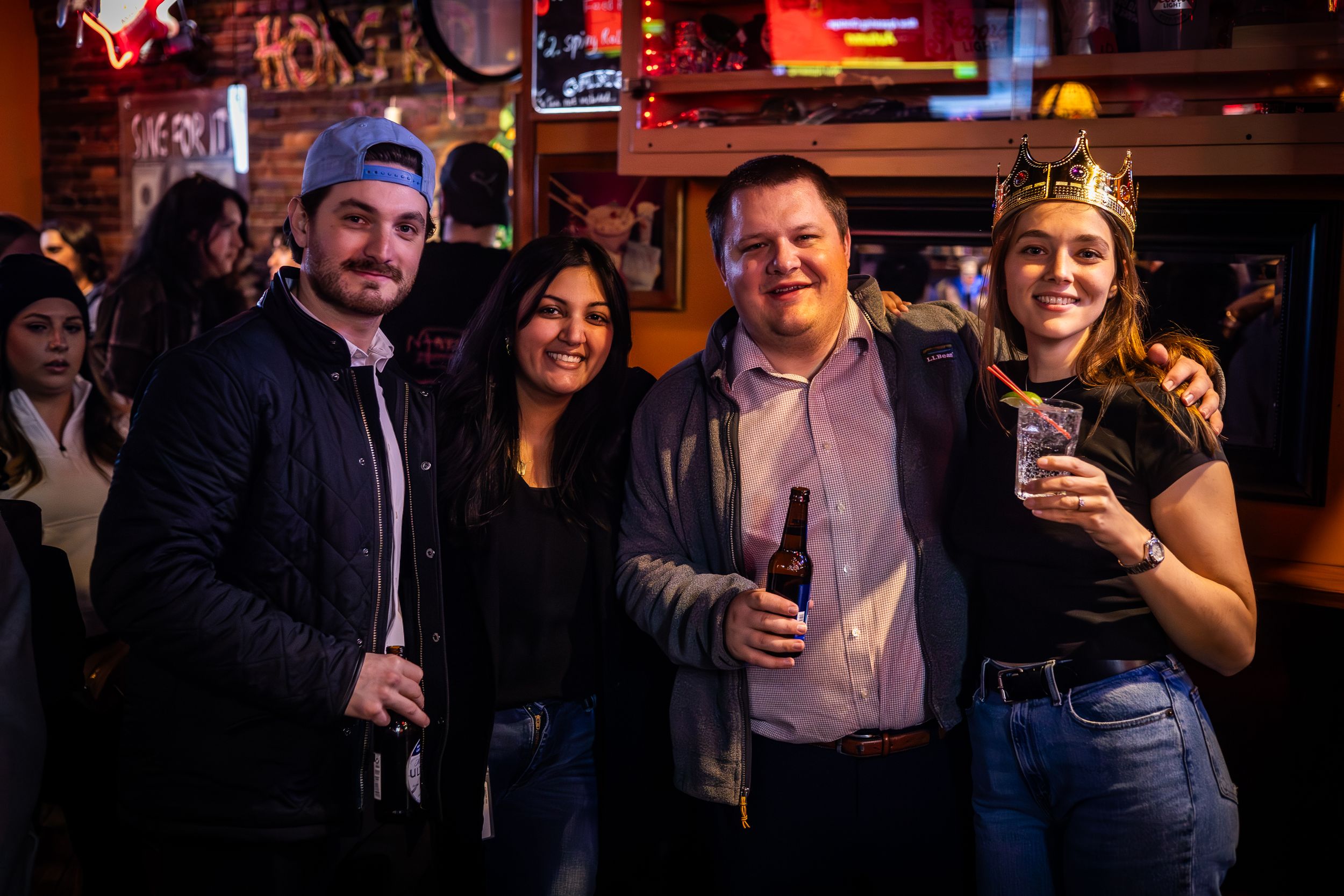 Group enjoying drinks and socializing at casual bar gathering.