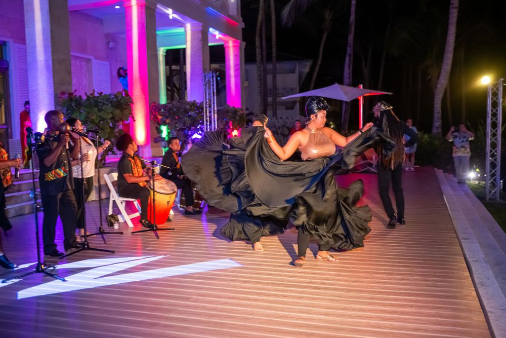 Evening dance performance on illuminated deck with colorful lighting effects.
