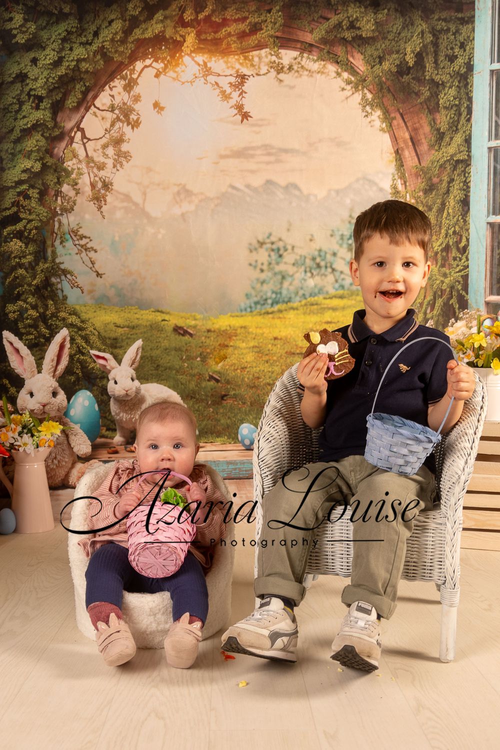 Whimsical Easter photography scene with bunny decorations and pastoral backdrop.