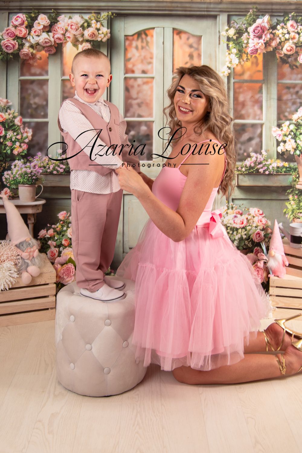Pink and pastel spring photo setup with floral window backdrop and ottoman prop.