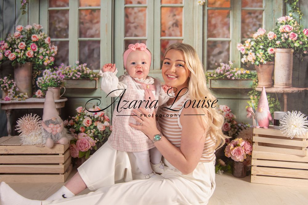 Spring portrait setup with romantic floral window backdrop and decorative props.