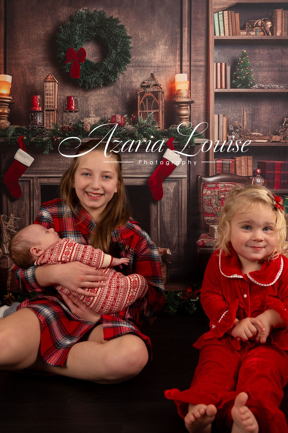Children posed together in red holiday outfits by a decorated Christmas fireplace.