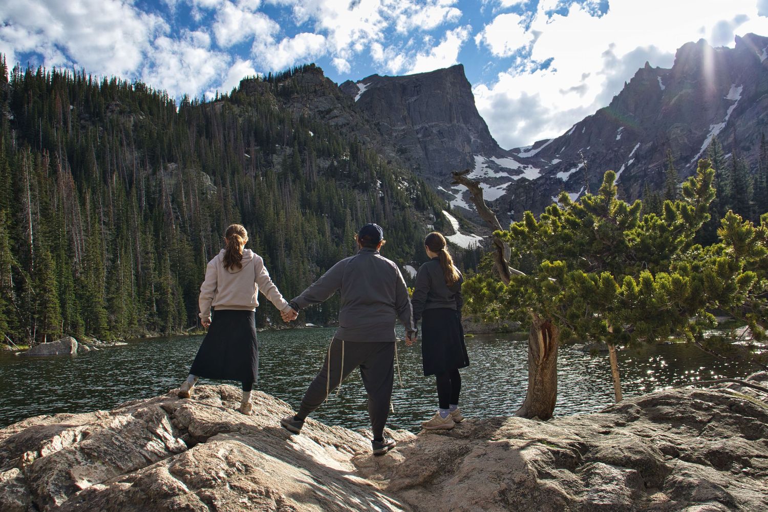 Family of 4 standing on frozen Cub Lake