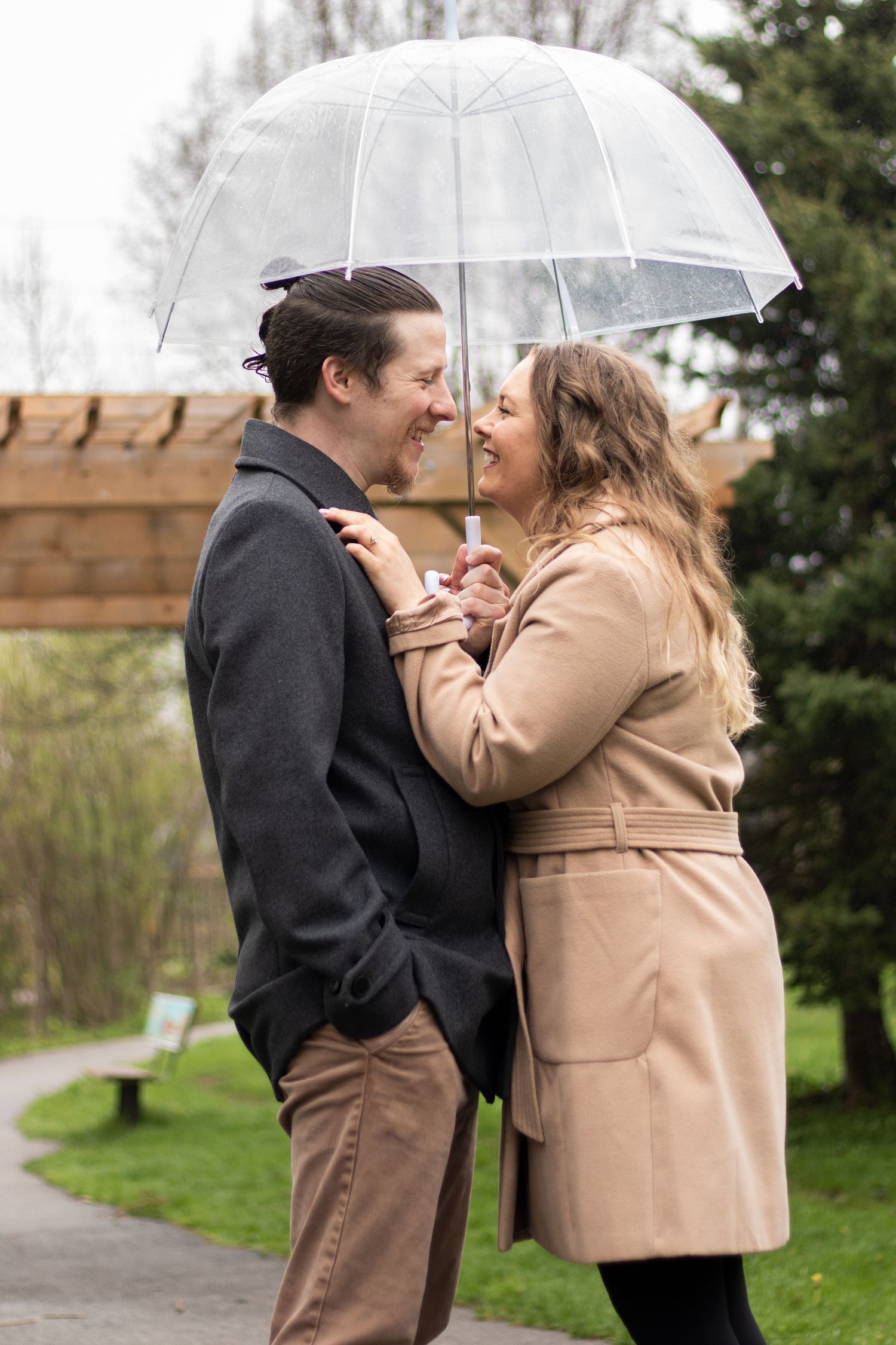Engaged couple under an umbrella
