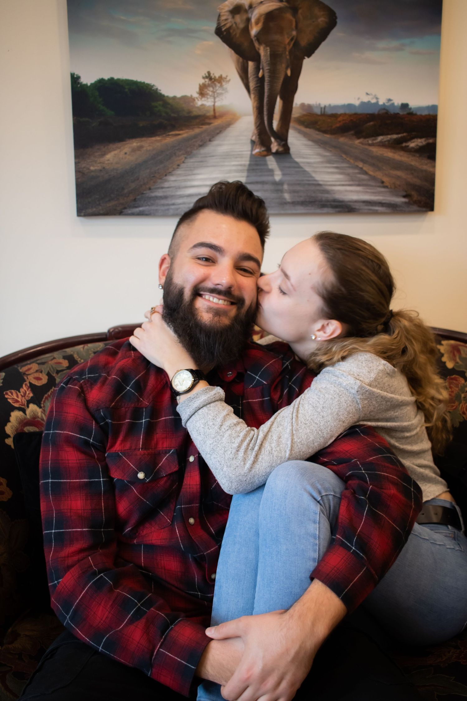A hetero couple cuddling on a couch