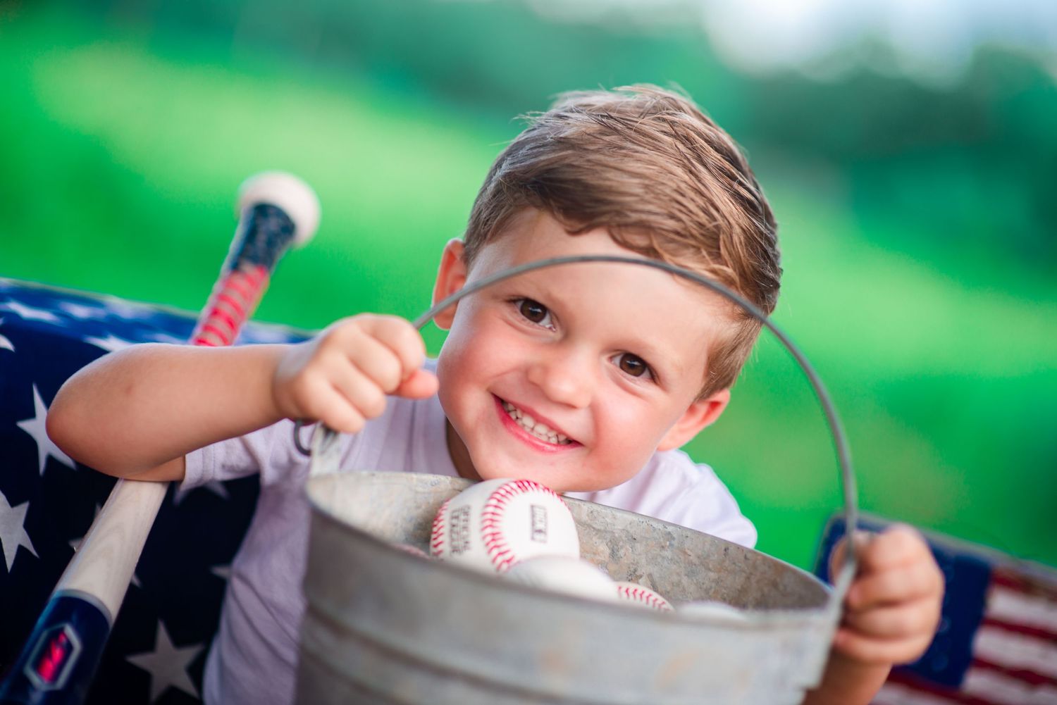 creative mini session little boy smiles custom set baseball bokeh natural light outside Alabama