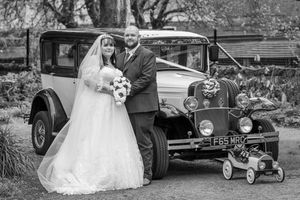 Vintage-inspired black and white wedding photos showcase classic cars and elegant bridal moments alongside classic vehicles.