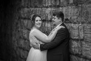 A wedding celebration collage showing intimate moments between a couple against a rustic stone wall backdrop.
