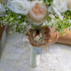 Bridal bouquet with white roses and a memorial photo charm pendant reading Walk with me today & always.