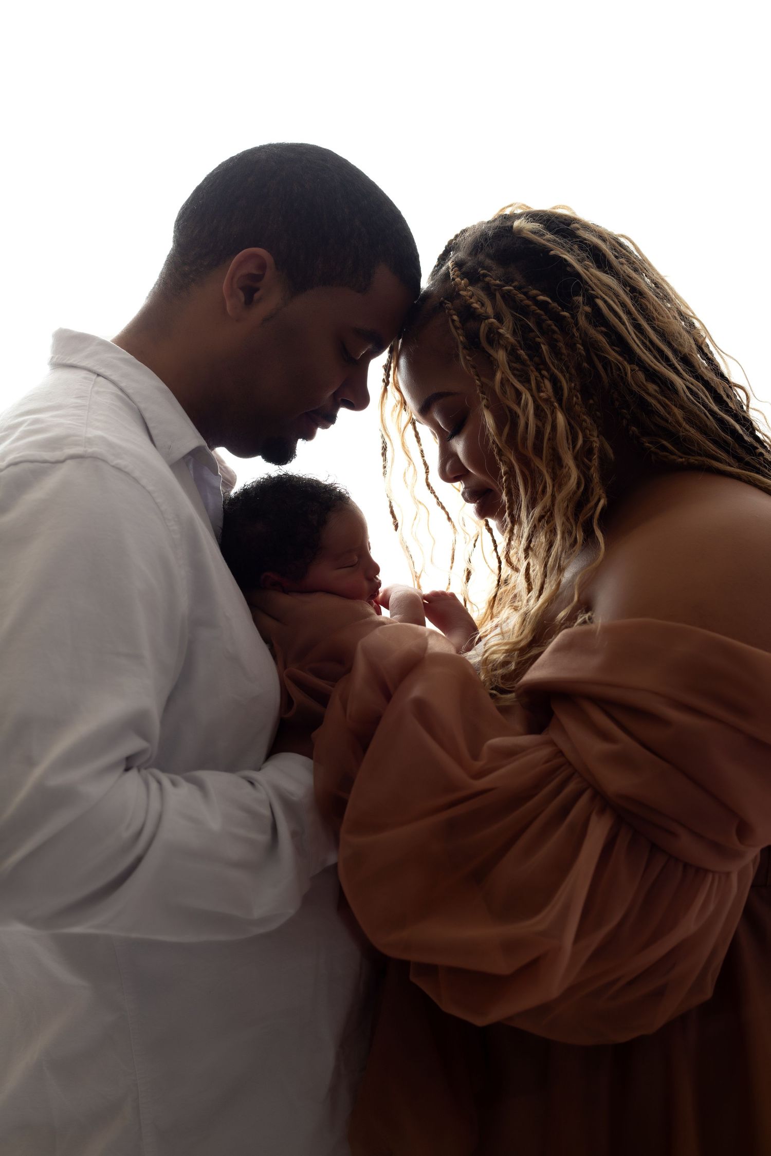 Intimate family portrait series with white backlit studio background.