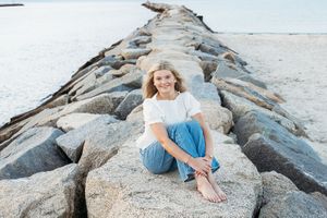A collection of coastal portraits showing someone posing on rocky shoreline formations at sunset.