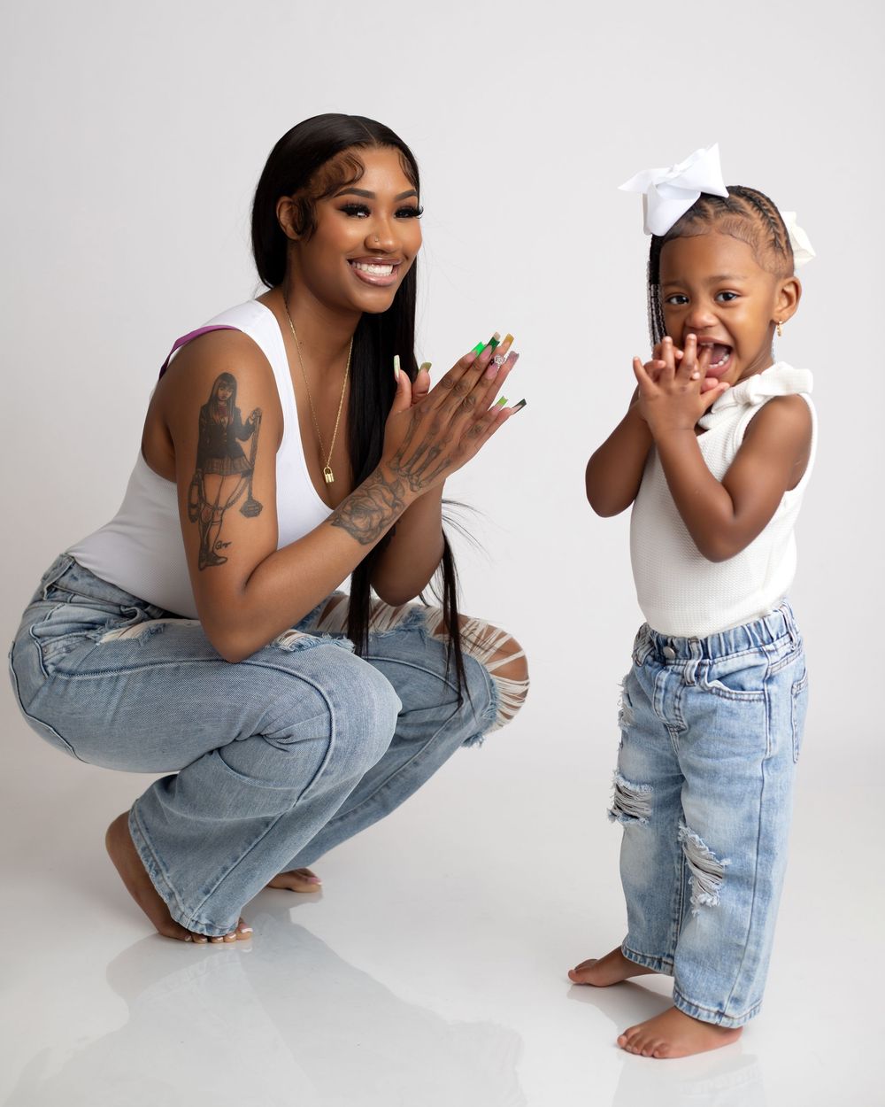 Playful poses of a parent and child in coordinated outfits against a white studio background.
