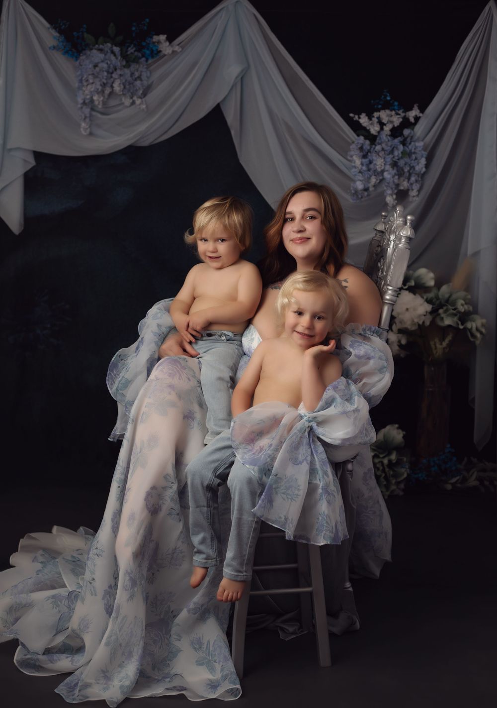 A series of ethereal studio portraits with flowing white fabric and delicate blue tulle creating a dreamy atmosphere.