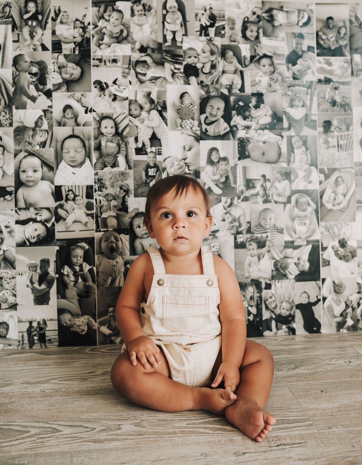 One-year-old celebrating first birthday with a cake smash in a high chair during a lifestyle milestone photo session.