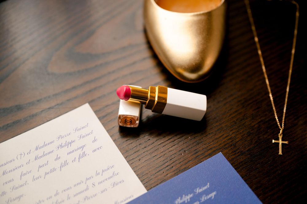 Handwritten letter on a dark wooden desk with a glowing lamp and writing tools in warm lighting.