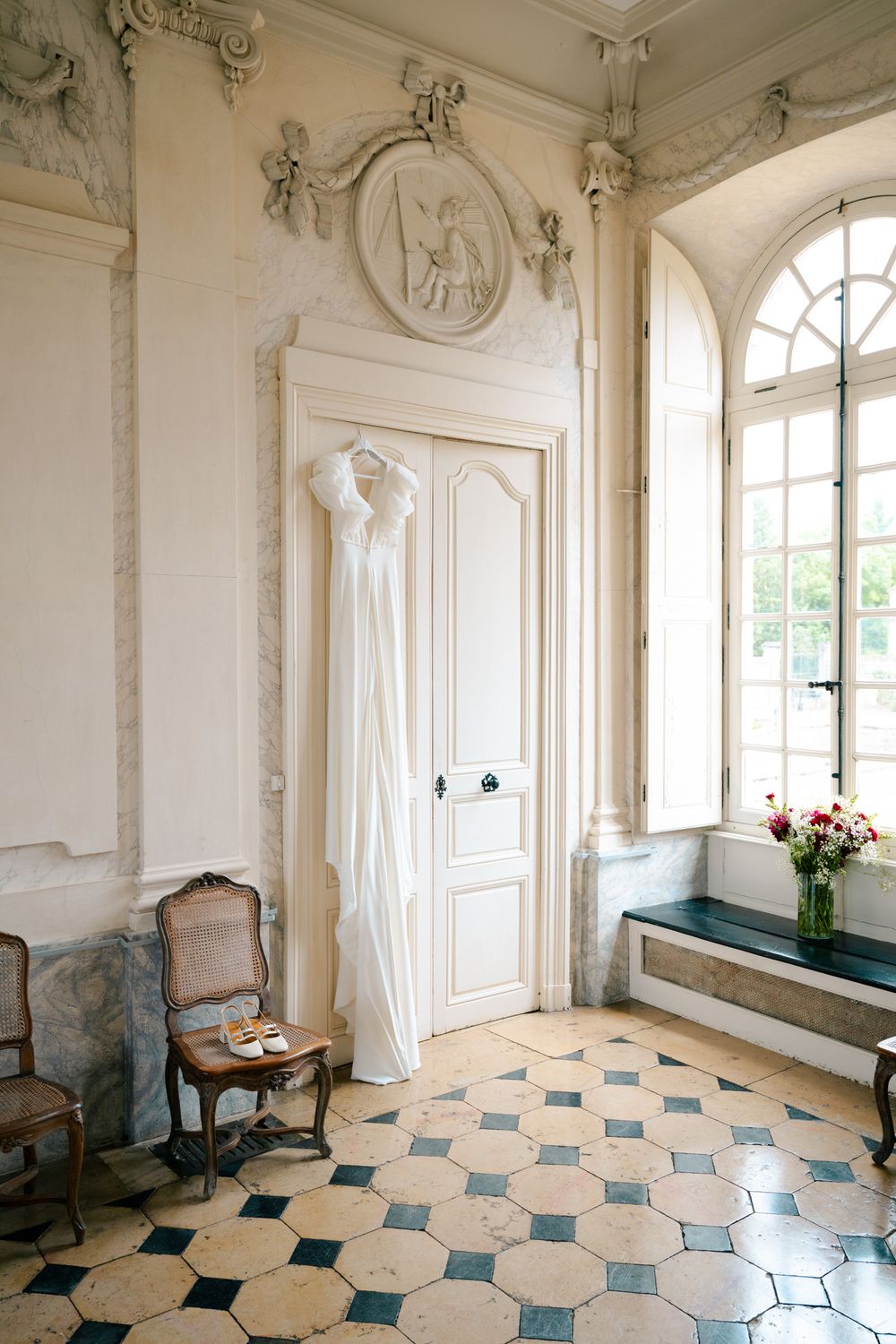 Elegant baroque room with white ornate walls and geometric blue and cream tiled floor pattern displayed in multiple angles.