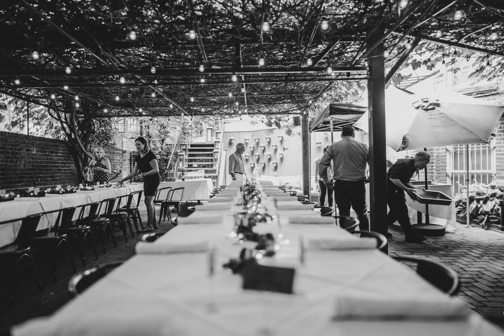 Black and white panoramic view of an empty outdoor seating area.