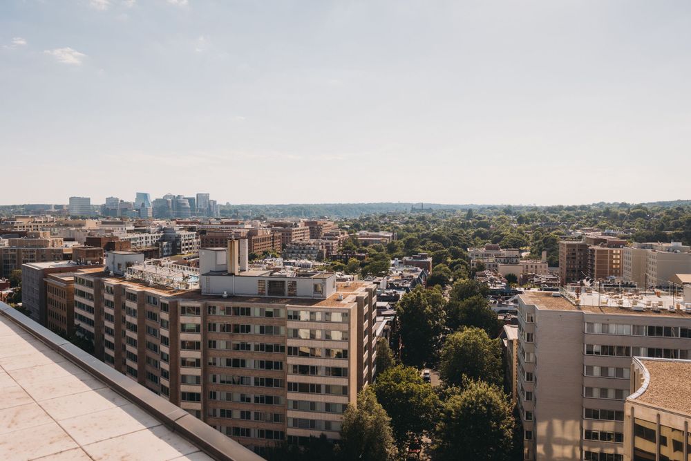 Panoramic cityscape view showing urban buildings and architecture against clear sky.