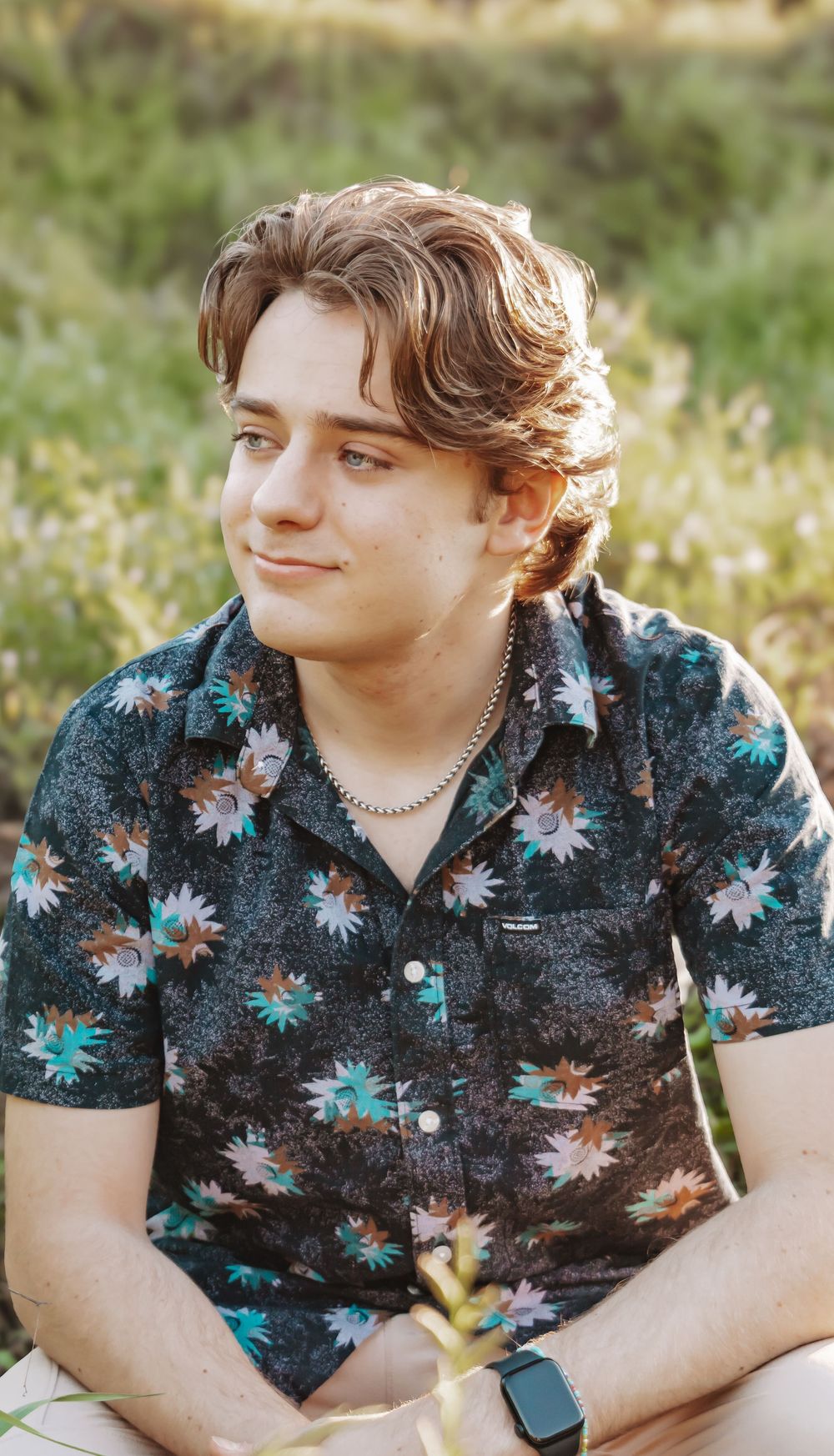 Teenage boy taking senior photos, looking into the distance.