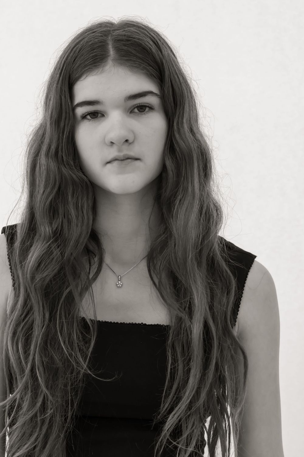 Serious face headshot of a girl in black and white.