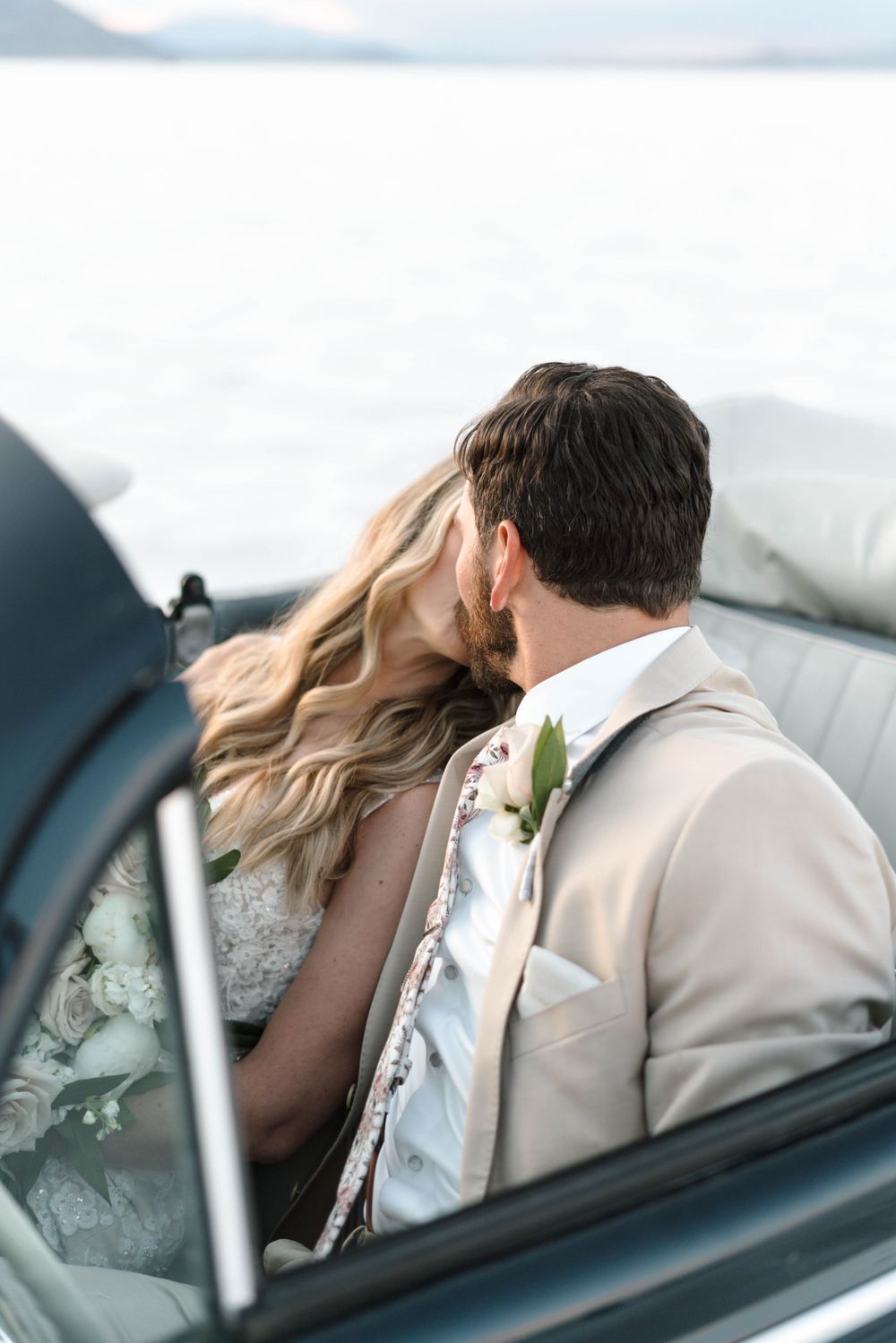 A romantic moment captured in a vintage convertible car.