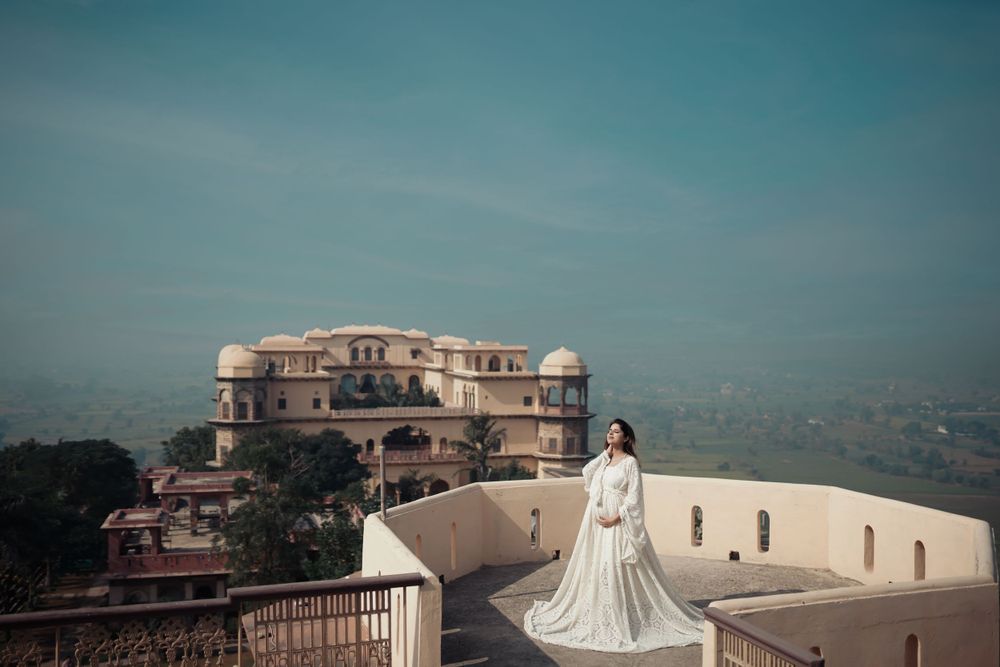 Elegant bridal portrait at historic palace with mountain vista background.